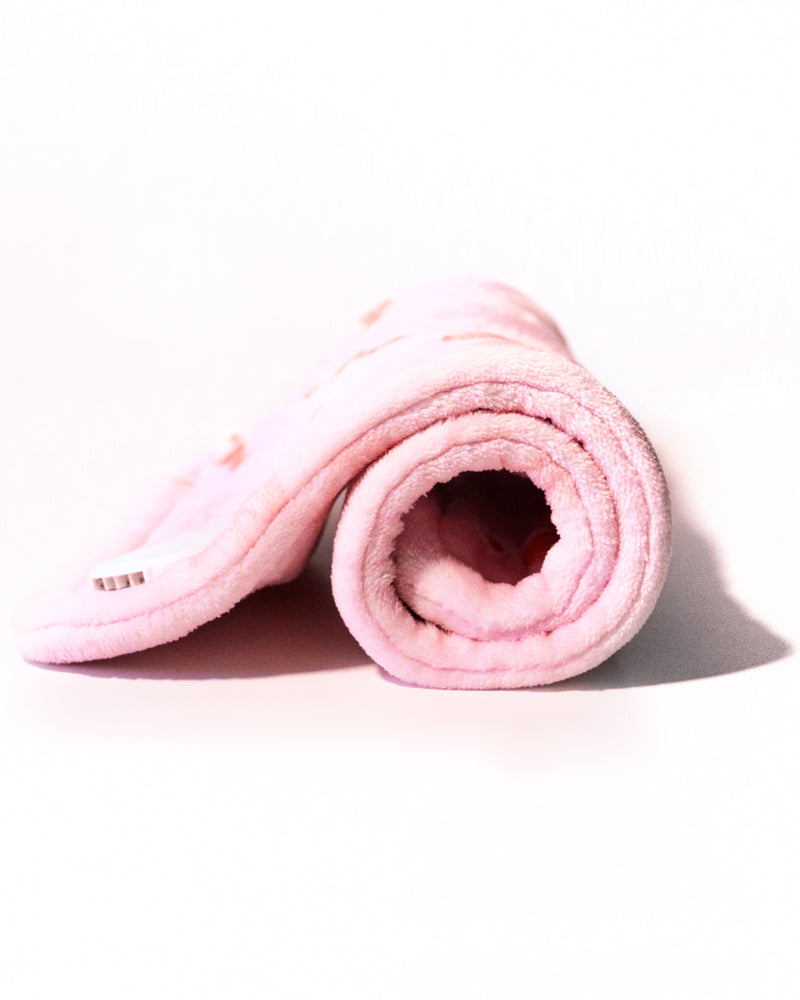 Cherry Heating Pad 🍒 rolled up showing plush pink fabric.